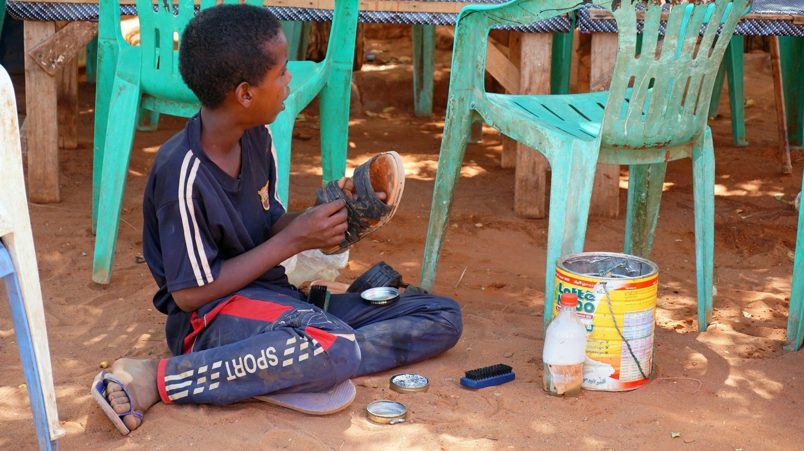 man in black and white crew neck t-shirt sitting on blue mat