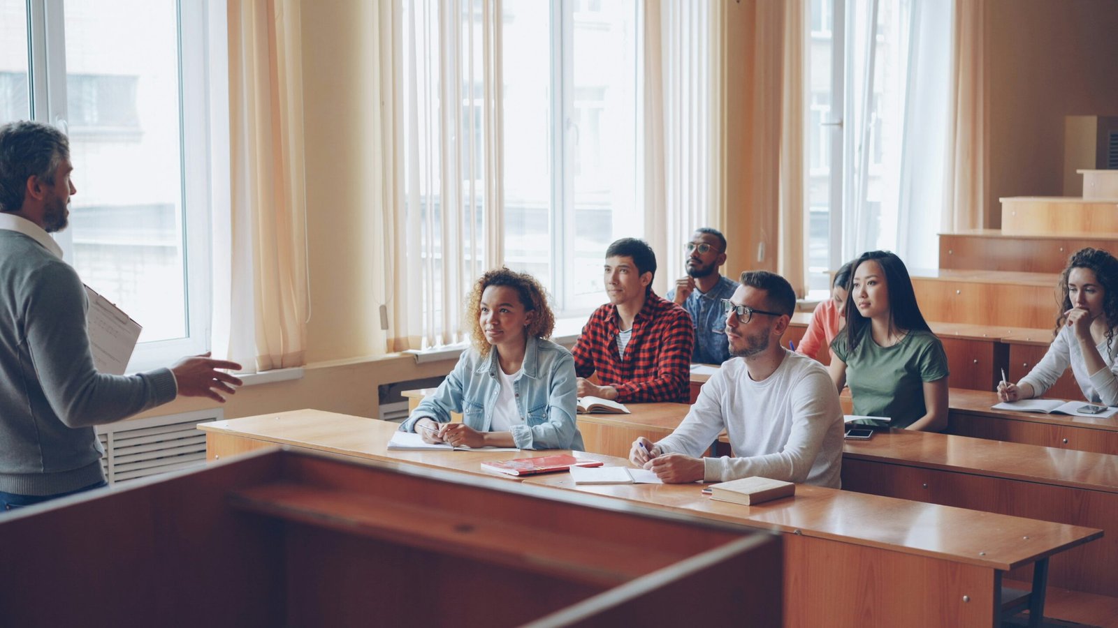 Professor lectures to students in a classroom setting.