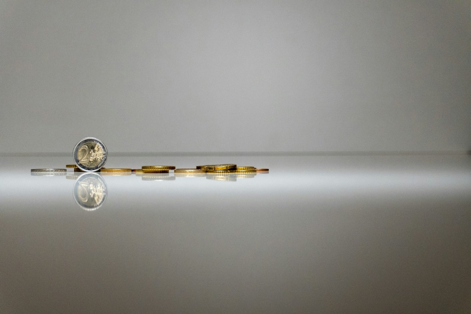 a stack of coins sitting on top of a reflective surface