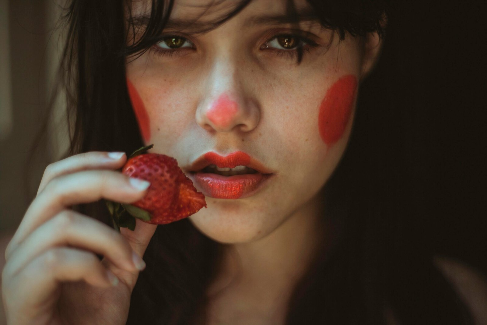 woman holding strawberry fruit