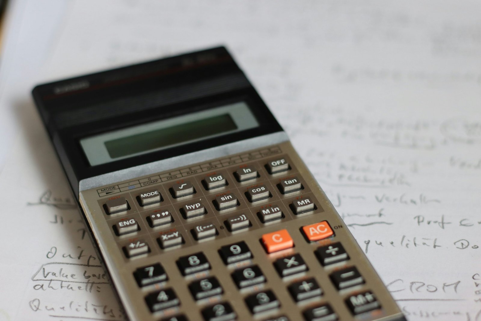 a calculator sitting on top of a piece of paper