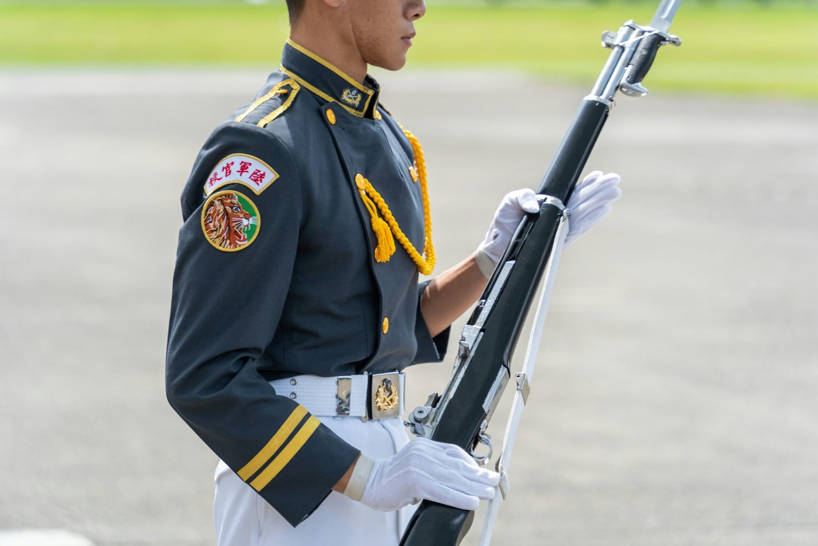 A man in military uniform holding a rifle