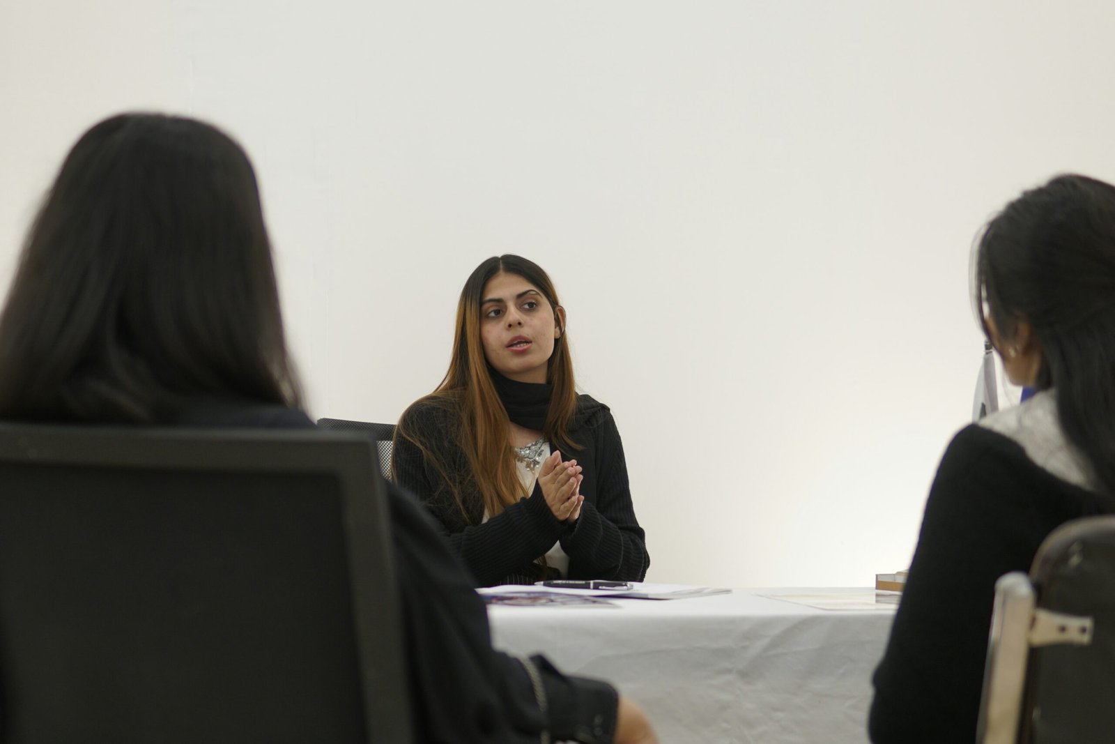 Woman speaking to two people across table
