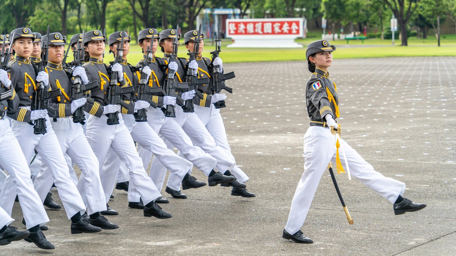 A group of men in uniform marching down a street
