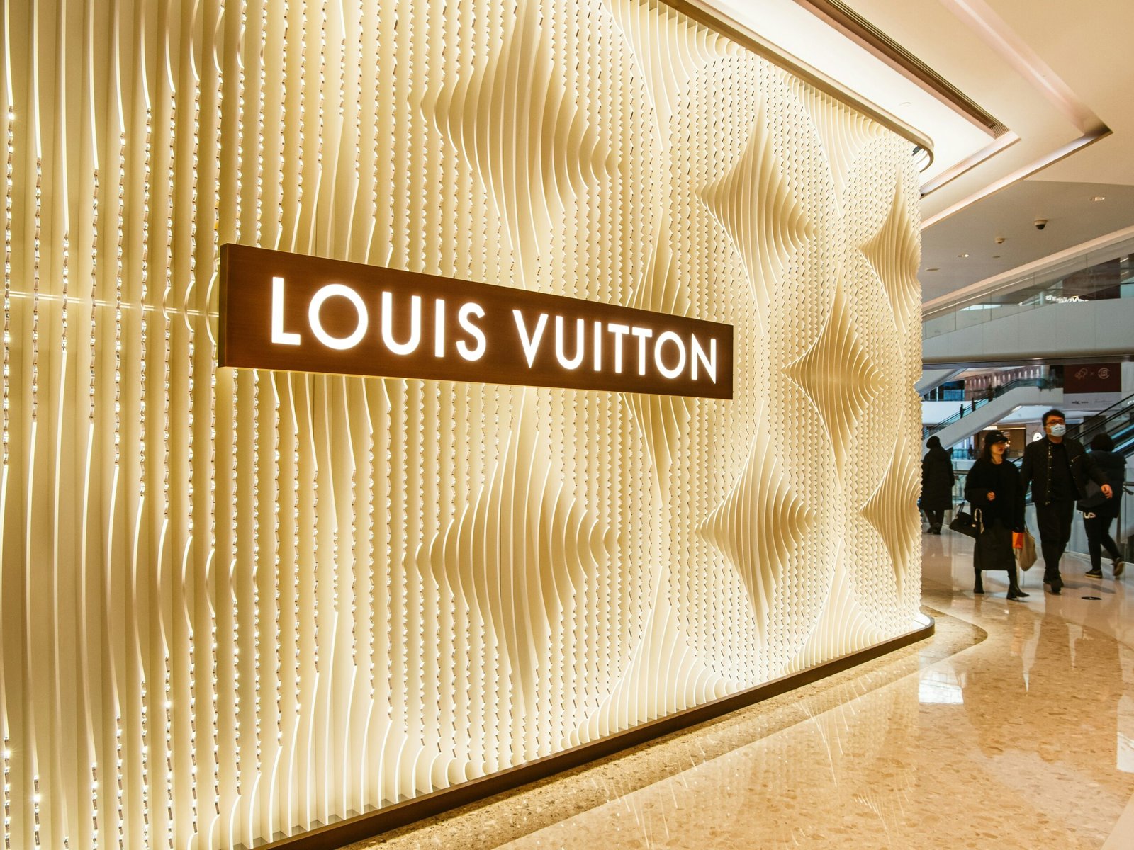 A group of people walking through a lobby