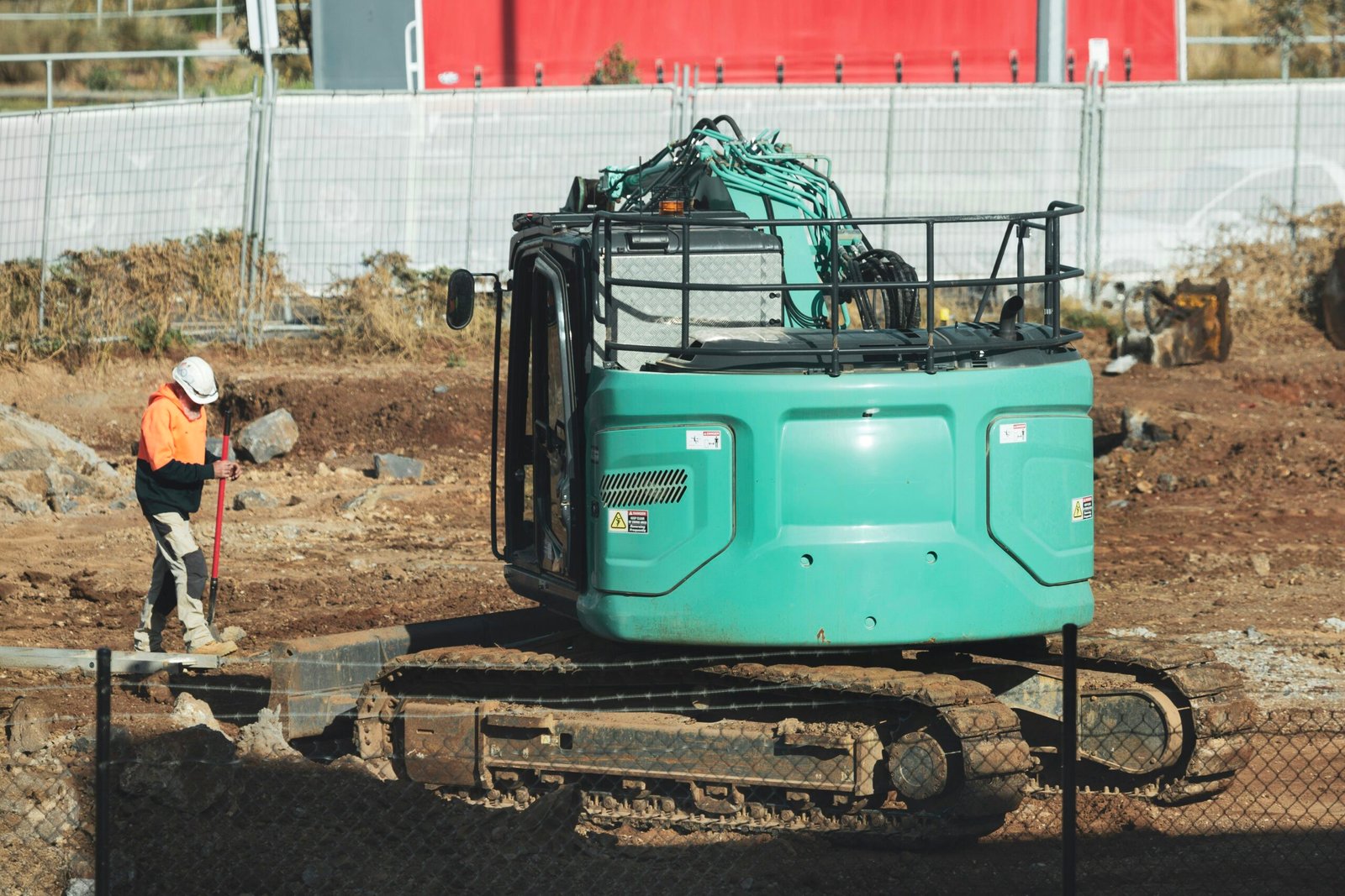 A man standing next to a green machine