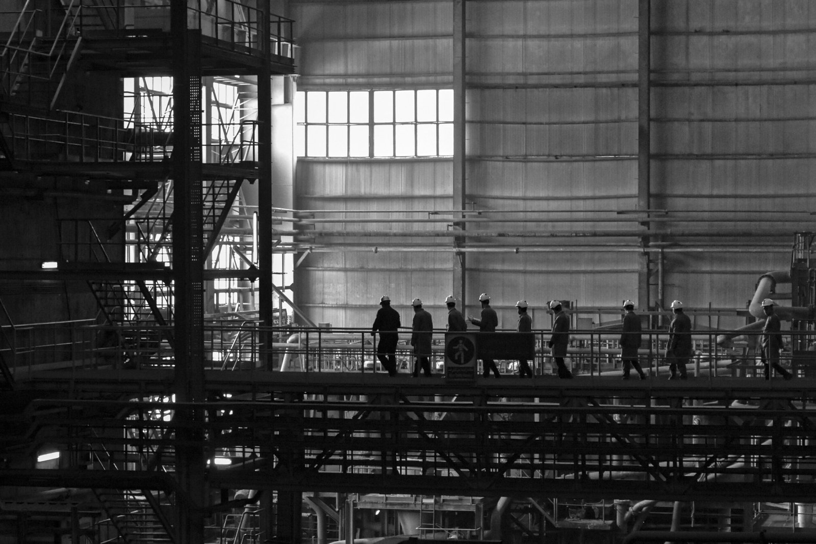 A group of people walking across a bridge