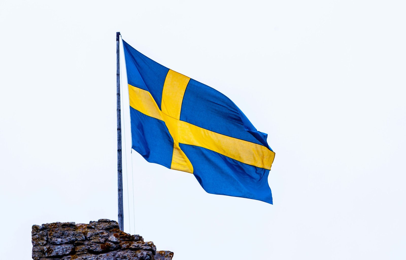 a blue and yellow flag flying on top of a building