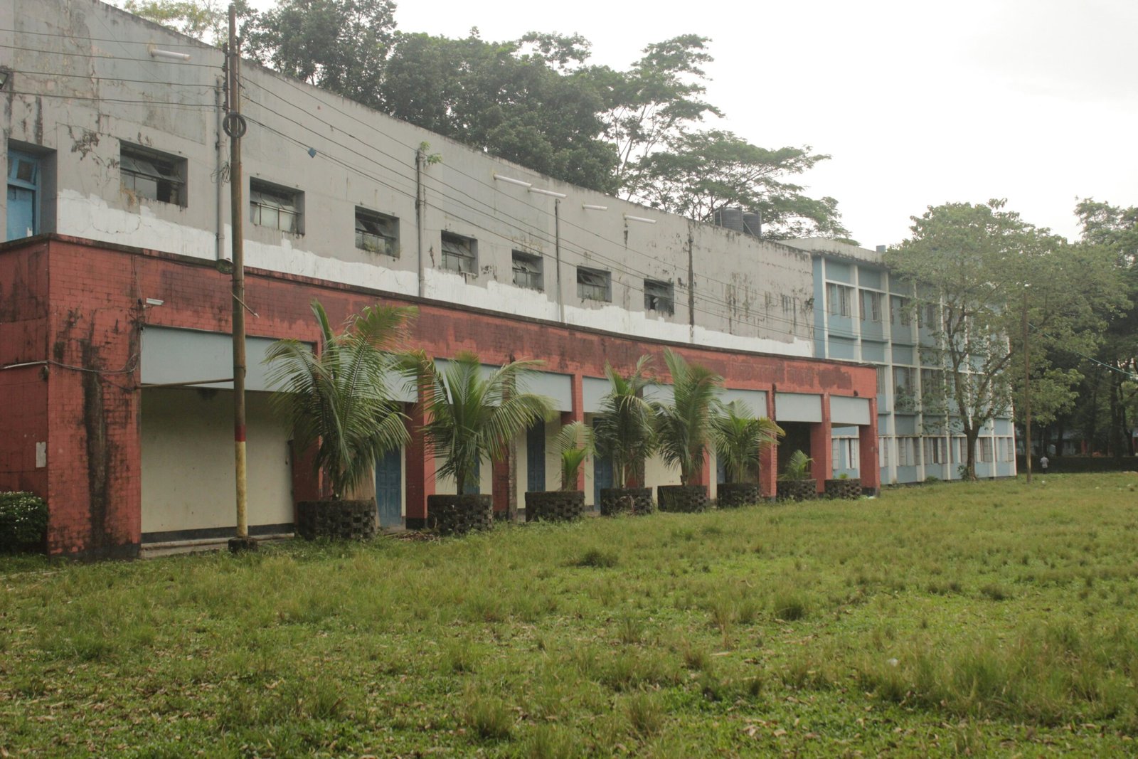 A large building sitting on top of a lush green field