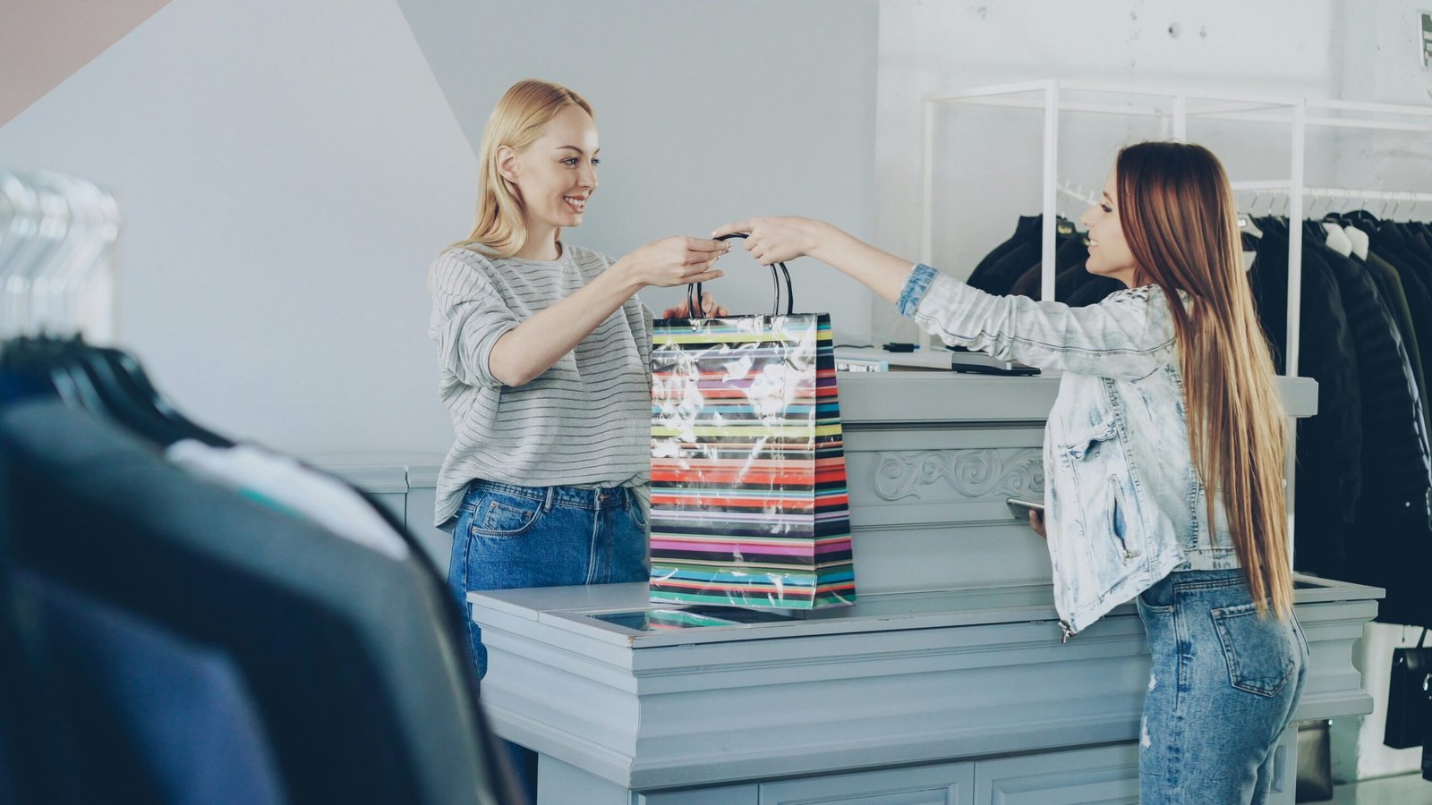 A customer receives a shopping bag at the store.