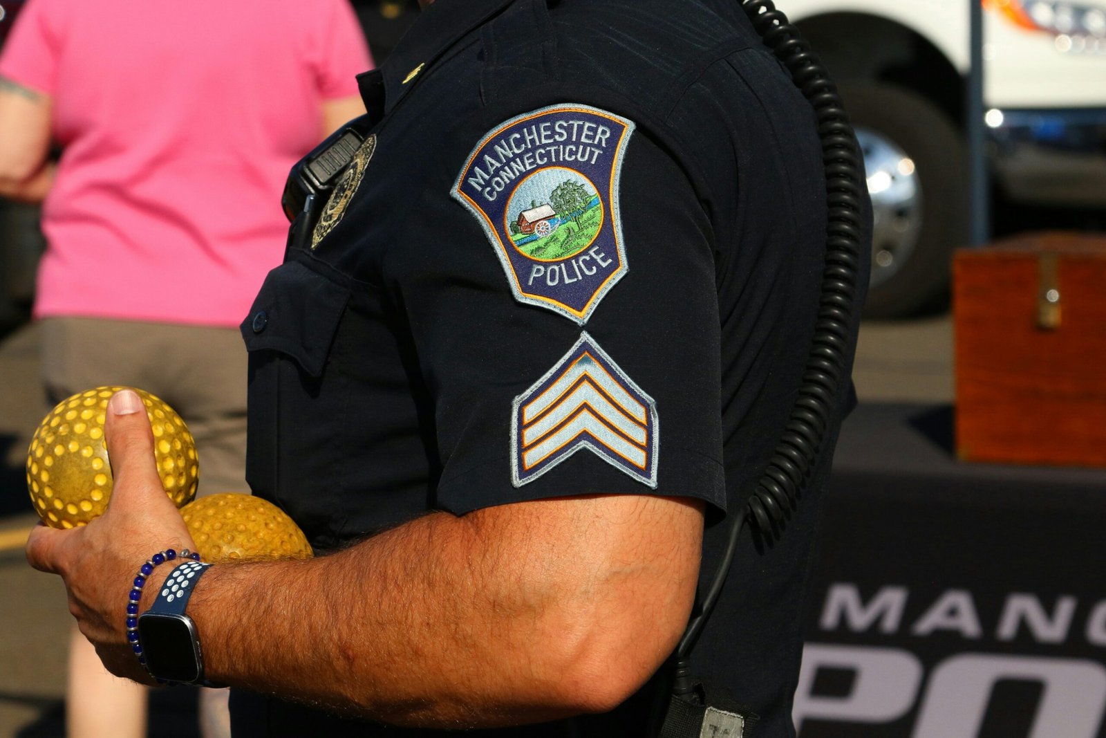 Police officer holding two golden balls