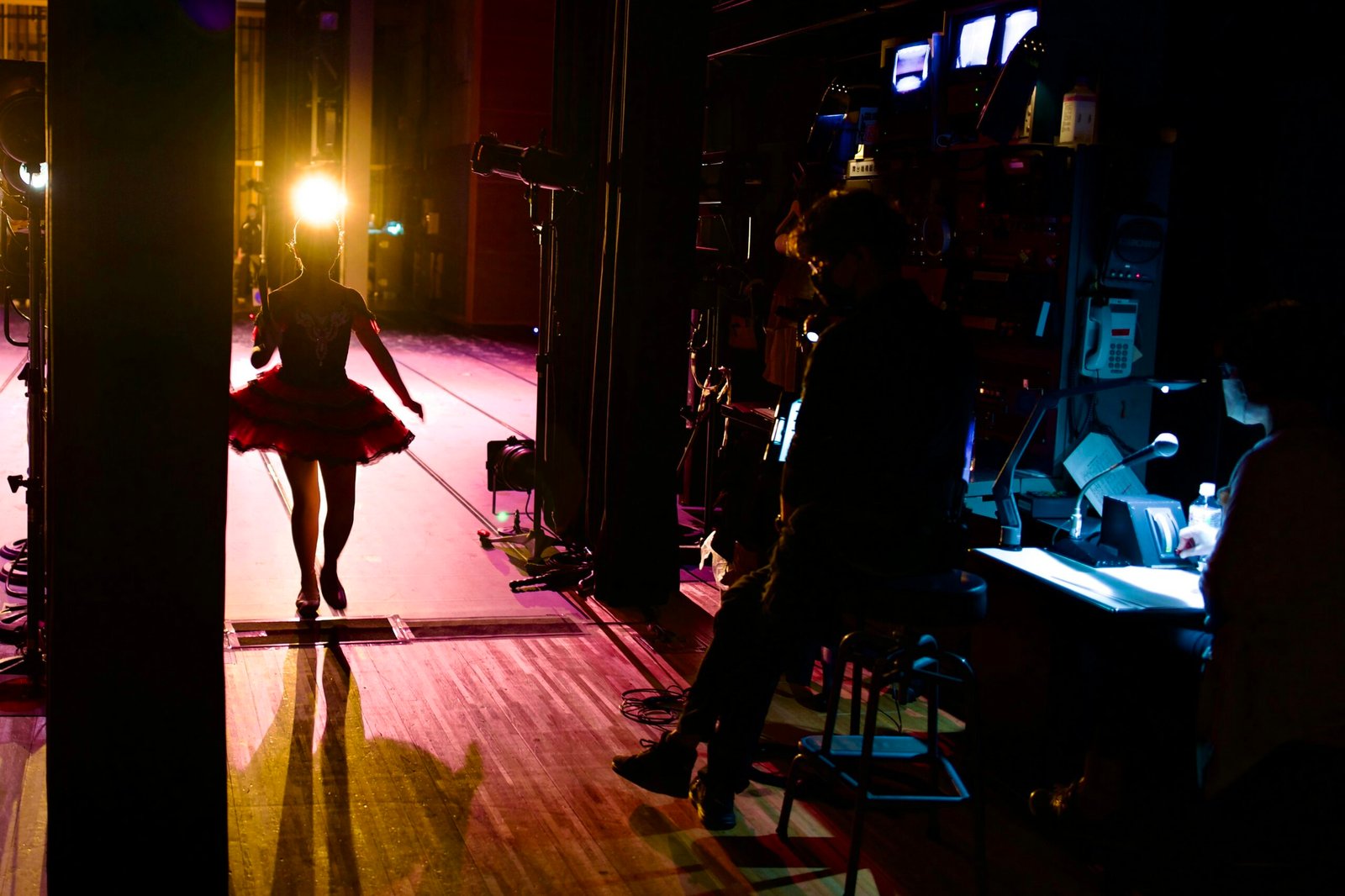 a woman in a red dress walking down a stage