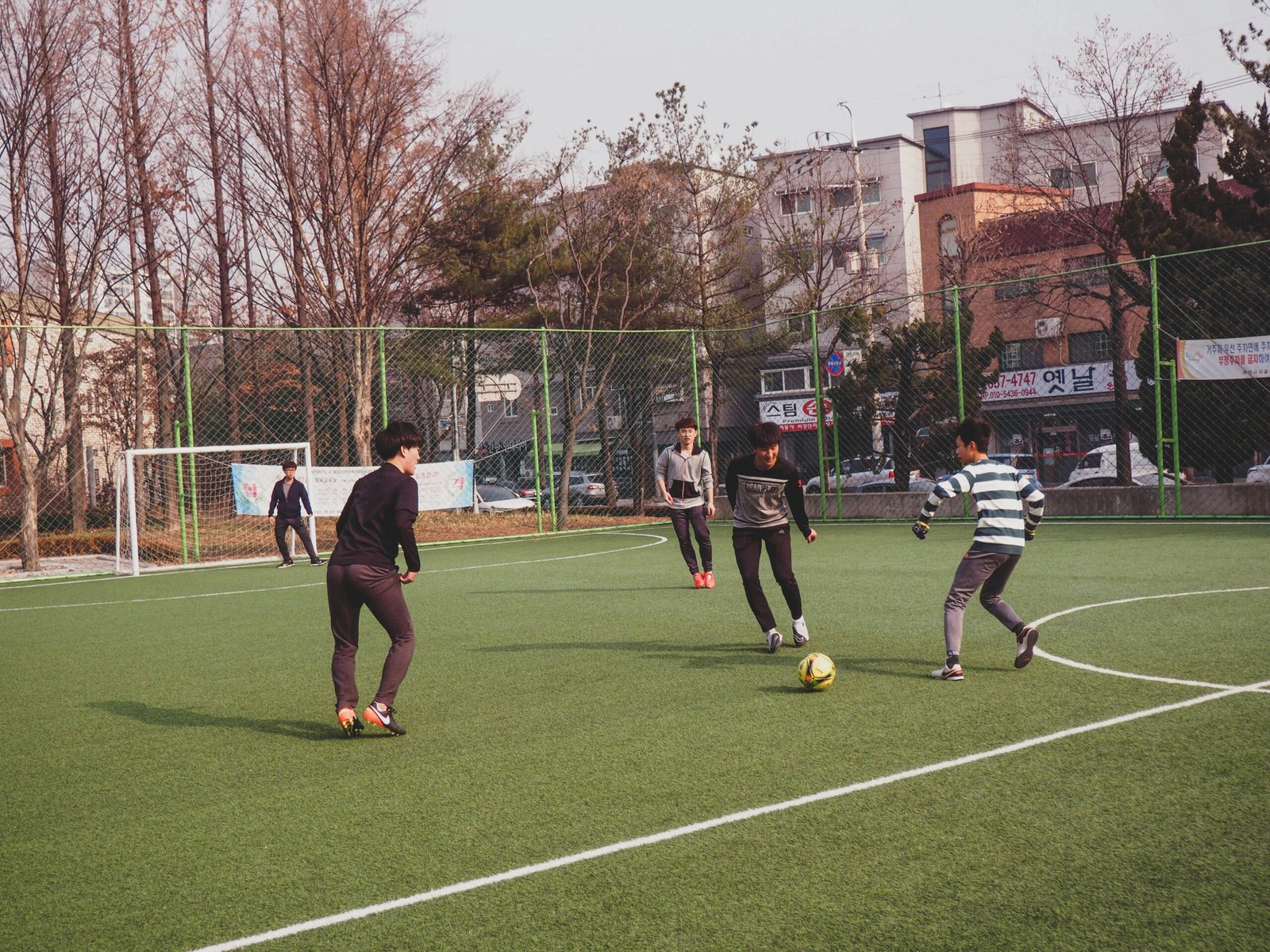 boys playing soccer on field