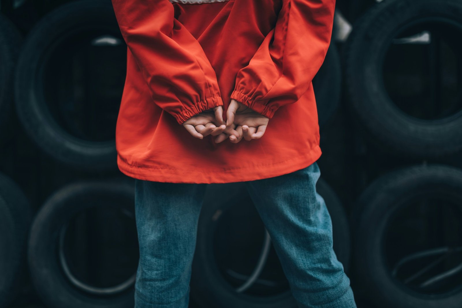 person in red hoodie and blue denim jeans