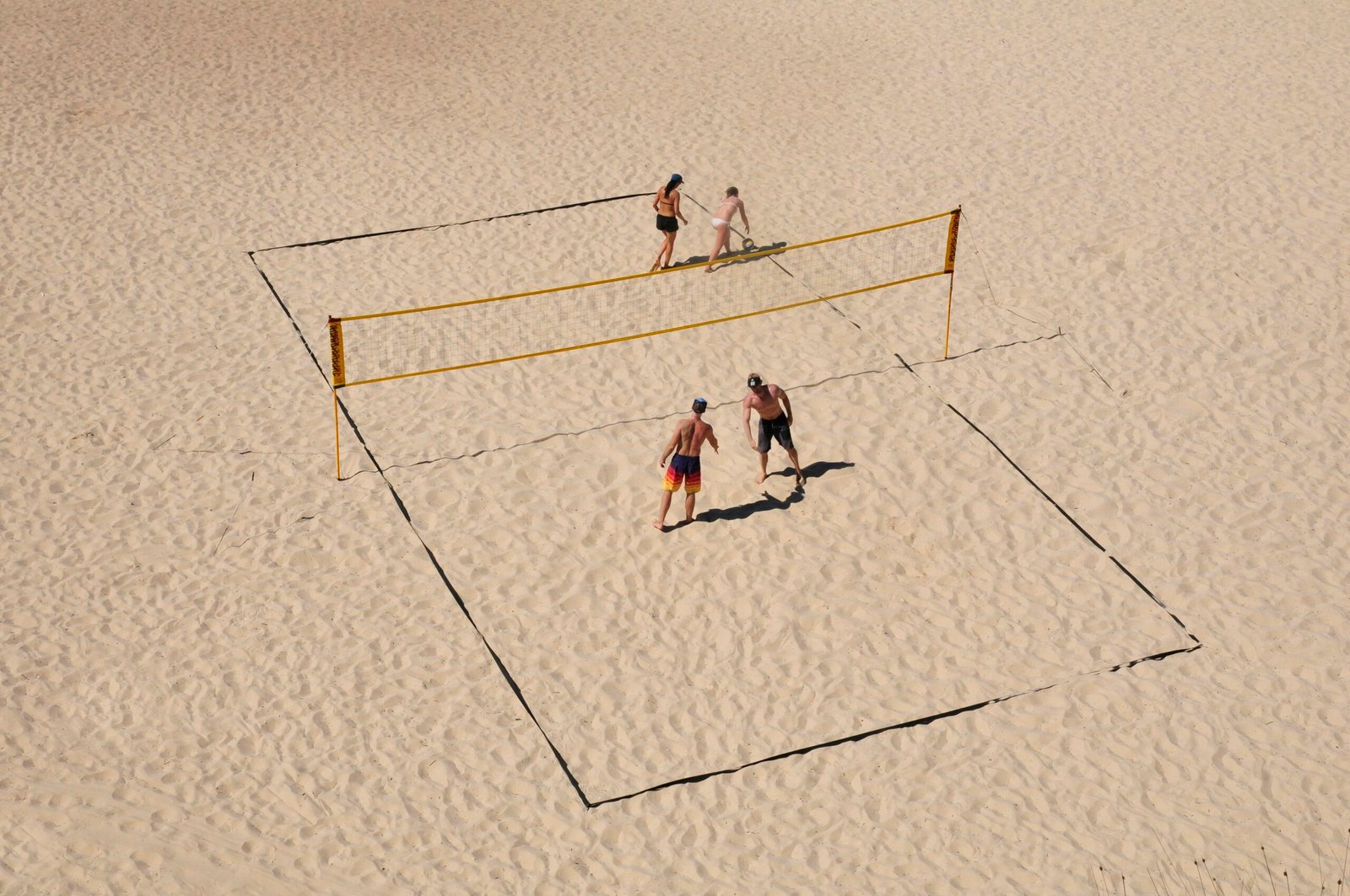 3 men playing basketball on white court