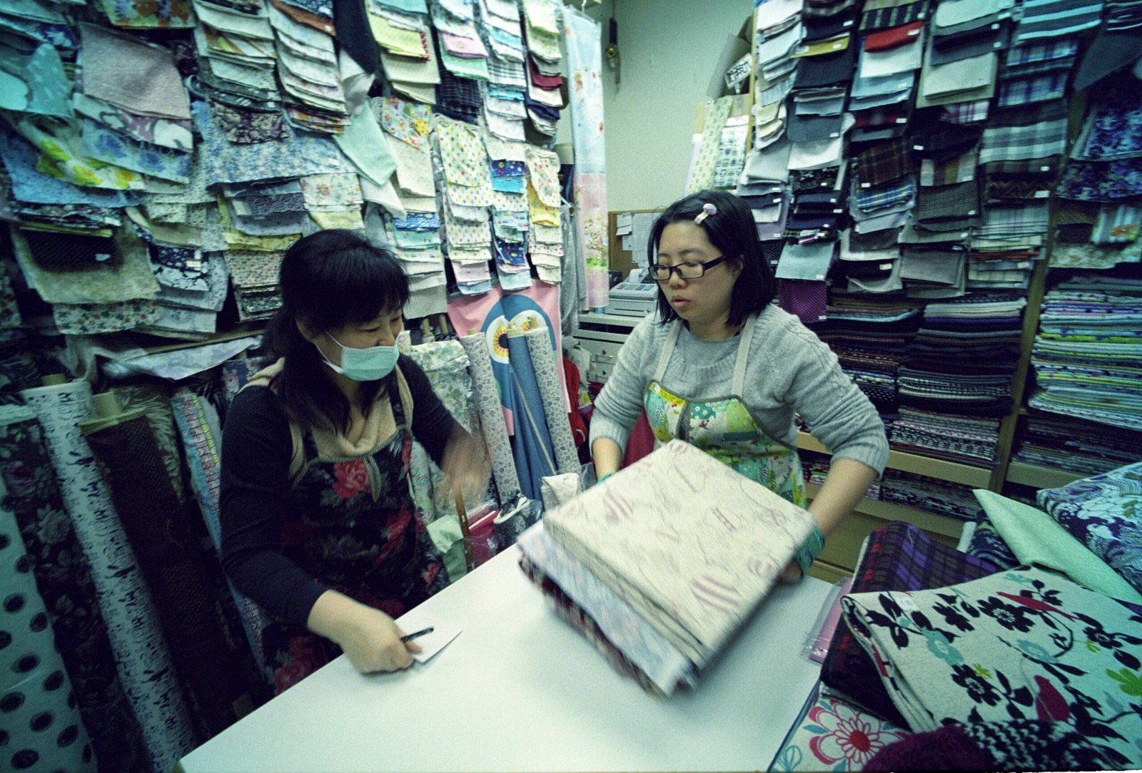 two women holding textiles
