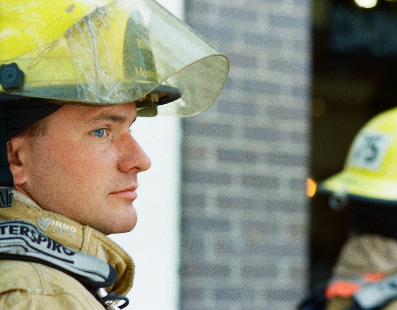 A fireman wearing a hard hat and protective gear