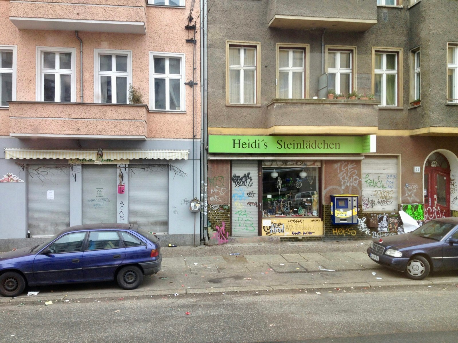 a blue car parked on the side of a street