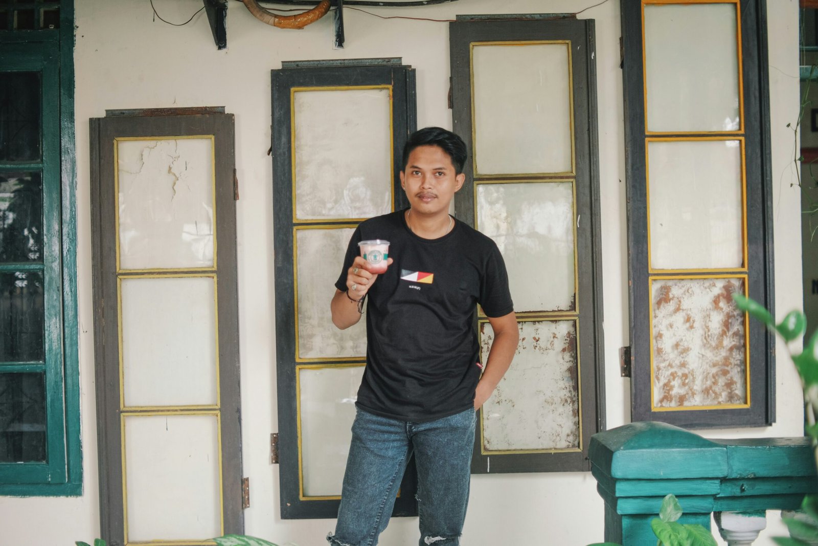 a man standing in front of a building holding a cell phone