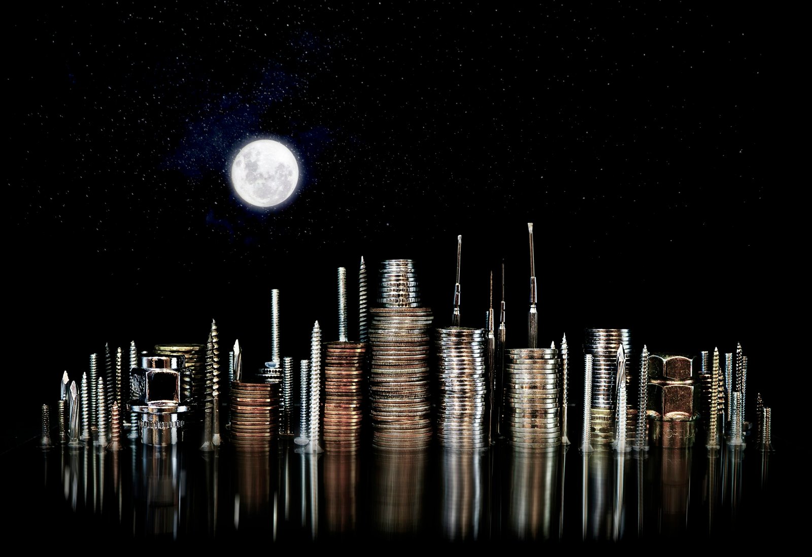 Cityscape made of coins under a full moon.