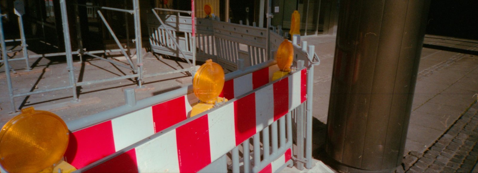 yellow and red balloons on white metal fence