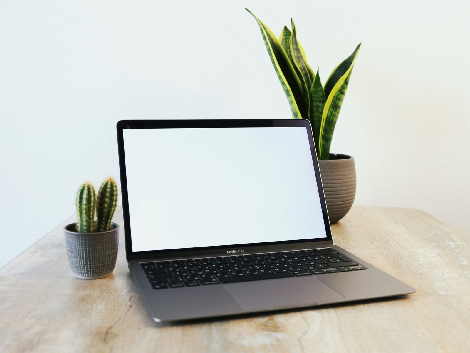 a laptop computer sitting on top of a wooden table