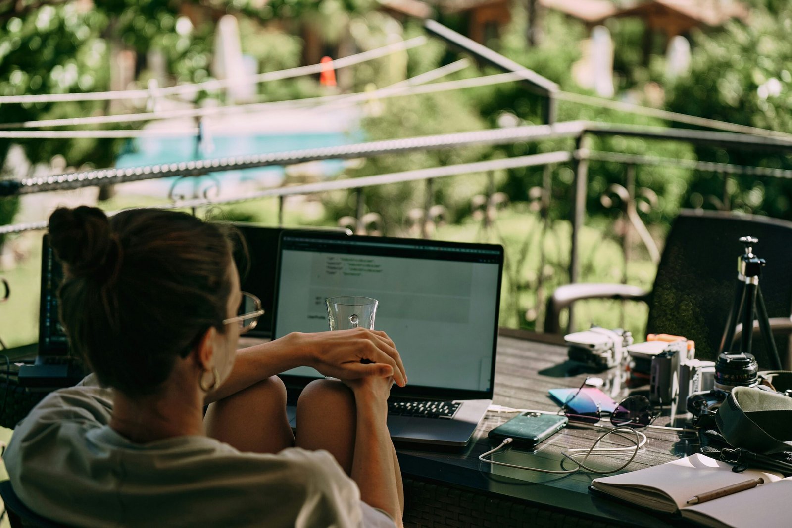a woman sitting at a table with a laptop