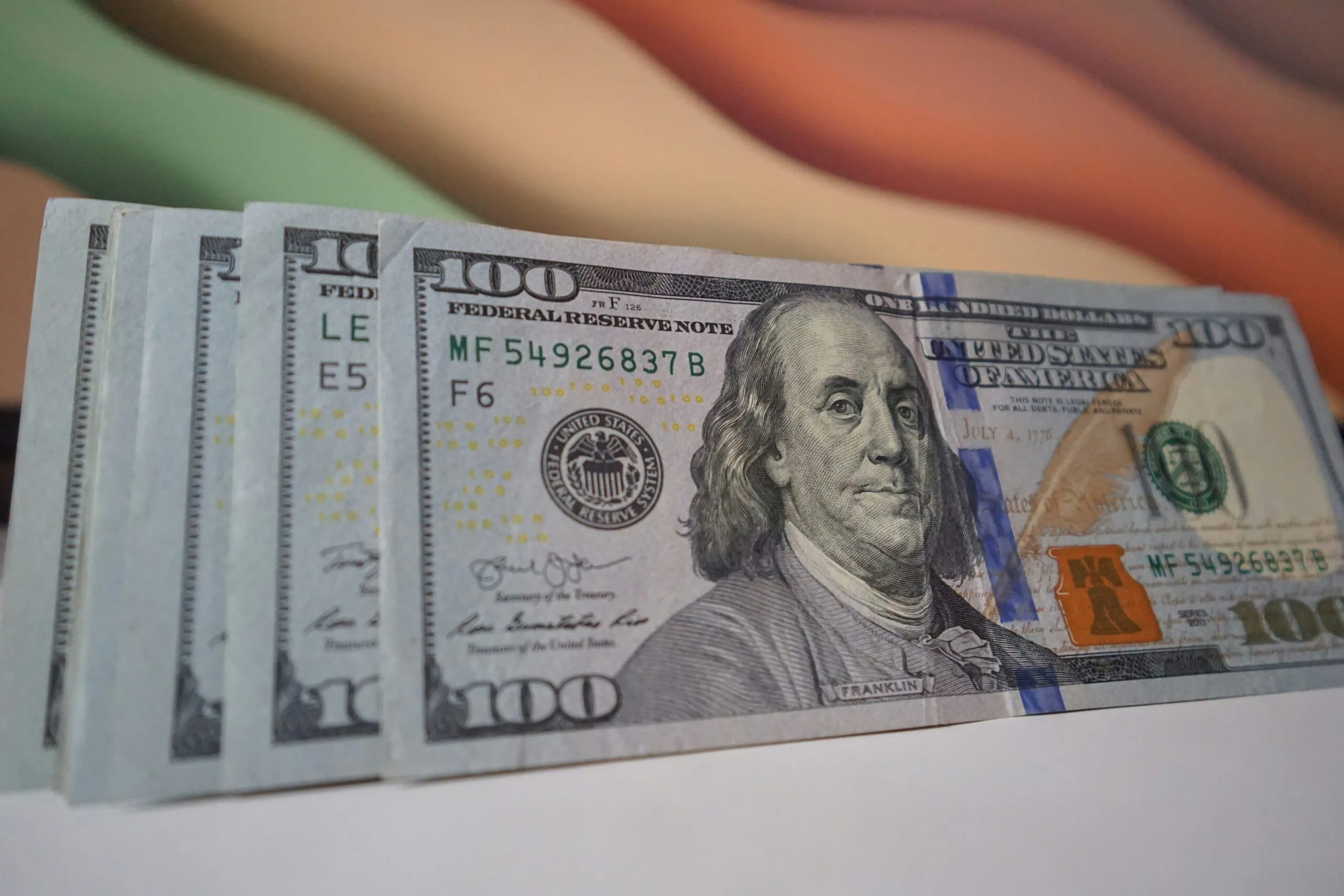 a stack of twenty dollar bills sitting on top of a table