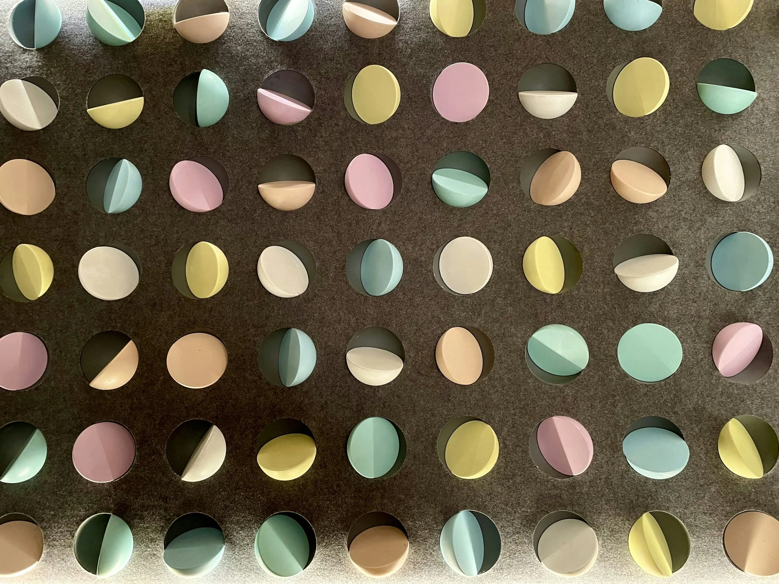 a group of different colored circles on a wall