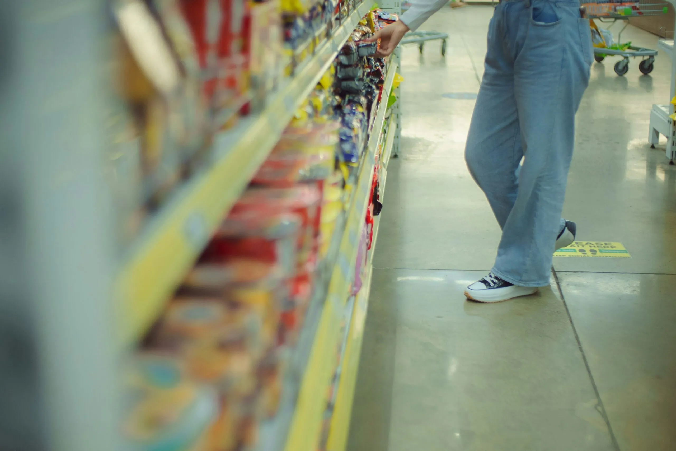 a man is shopping in a grocery store