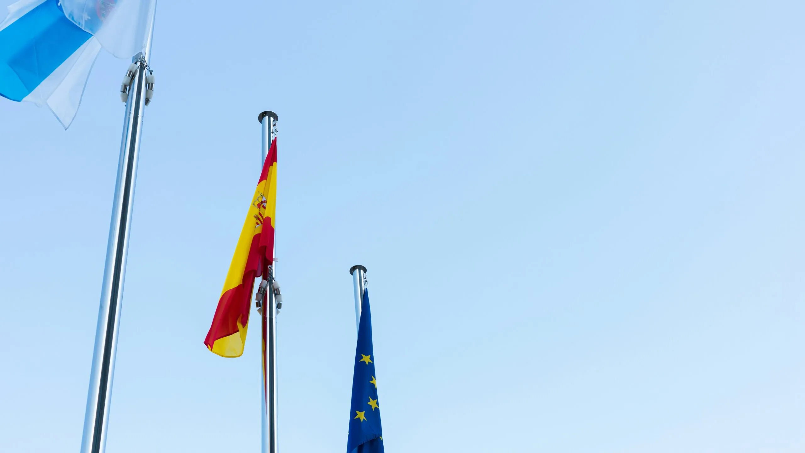 low-angle photography of three country flags