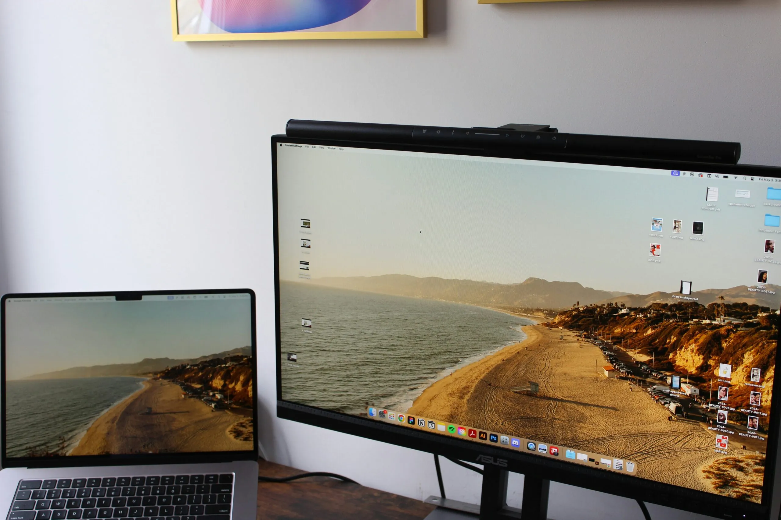 a laptop computer sitting on top of a desk next to a monitor