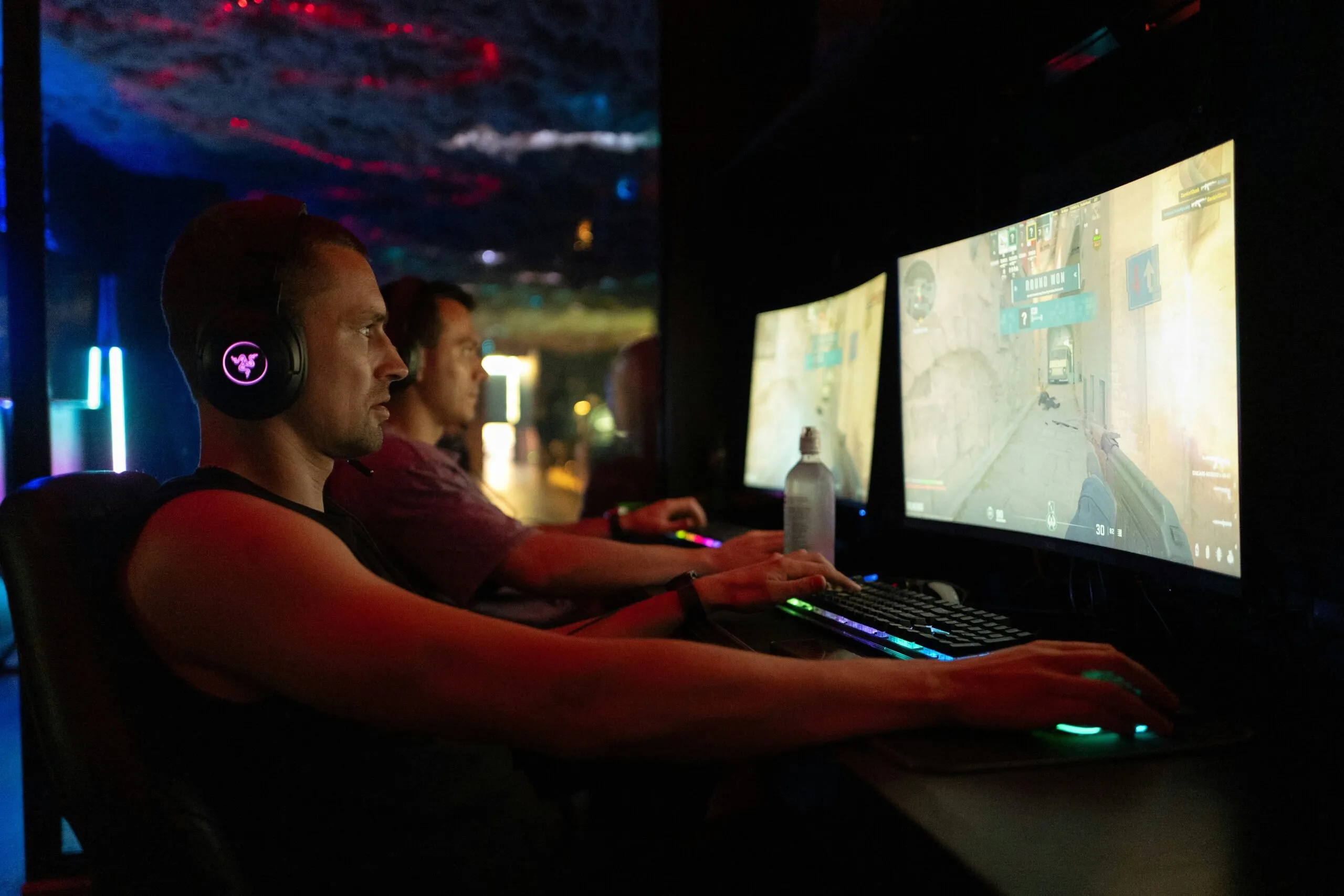 Two men playing video games on computers