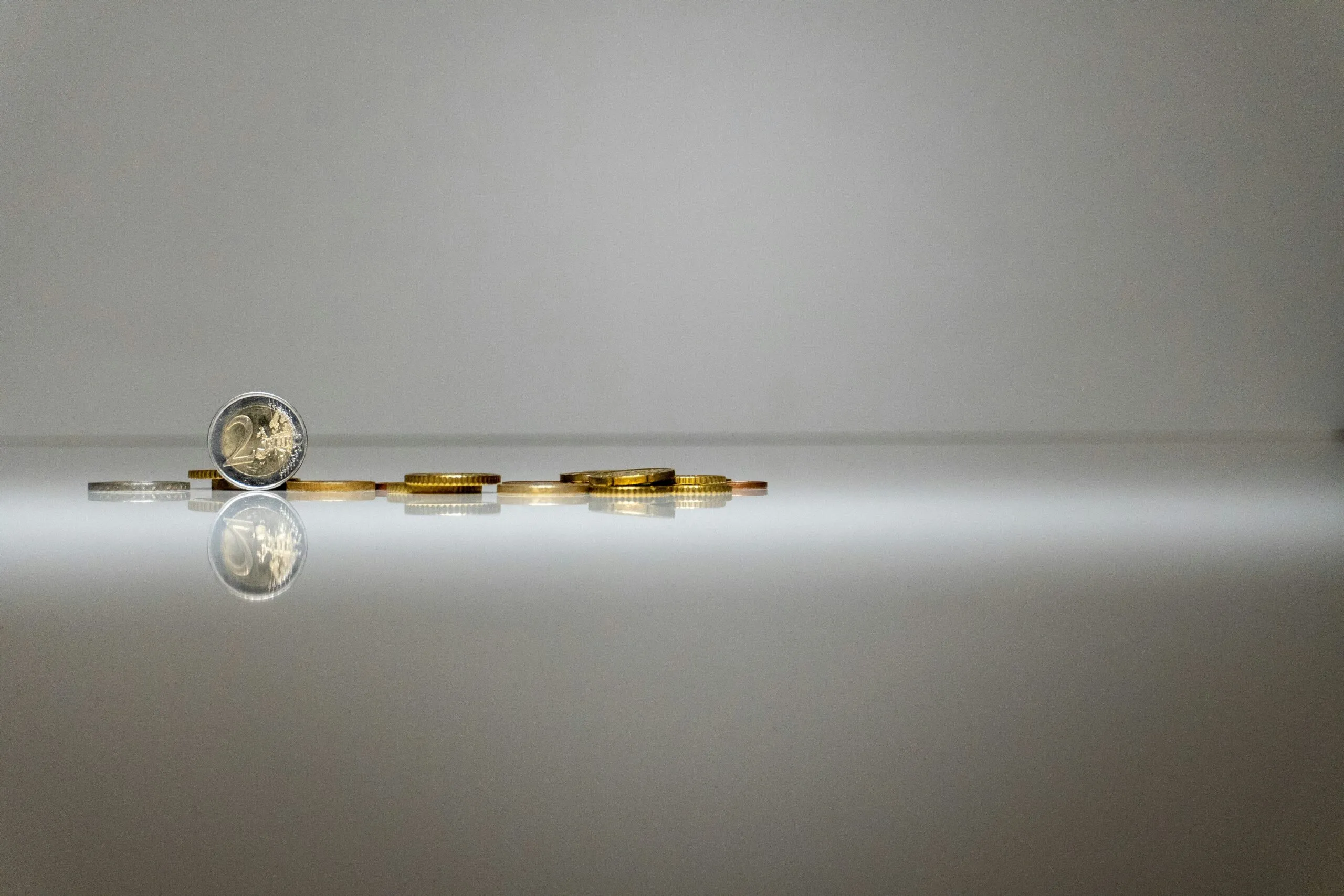 a stack of coins sitting on top of a reflective surface
