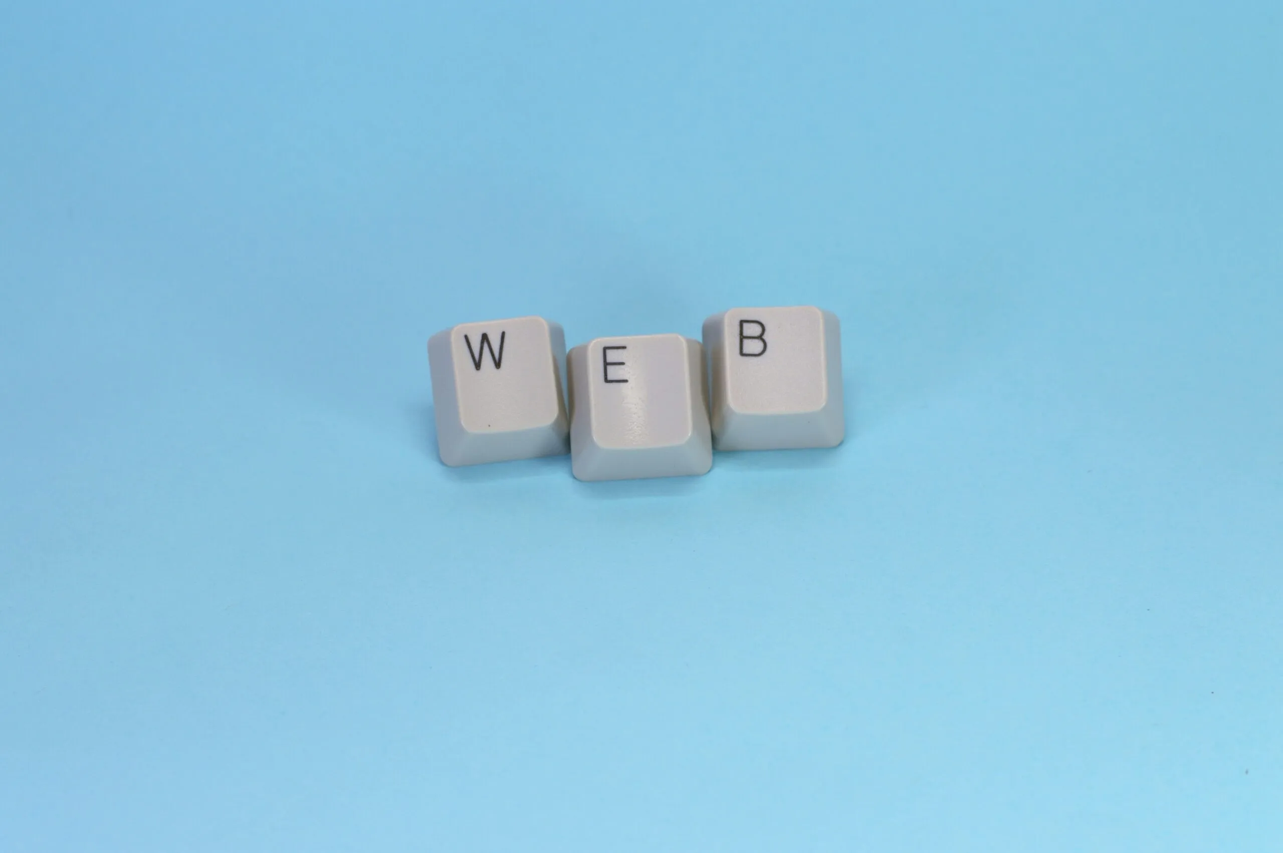 Keyboard keys spell out the word "web."