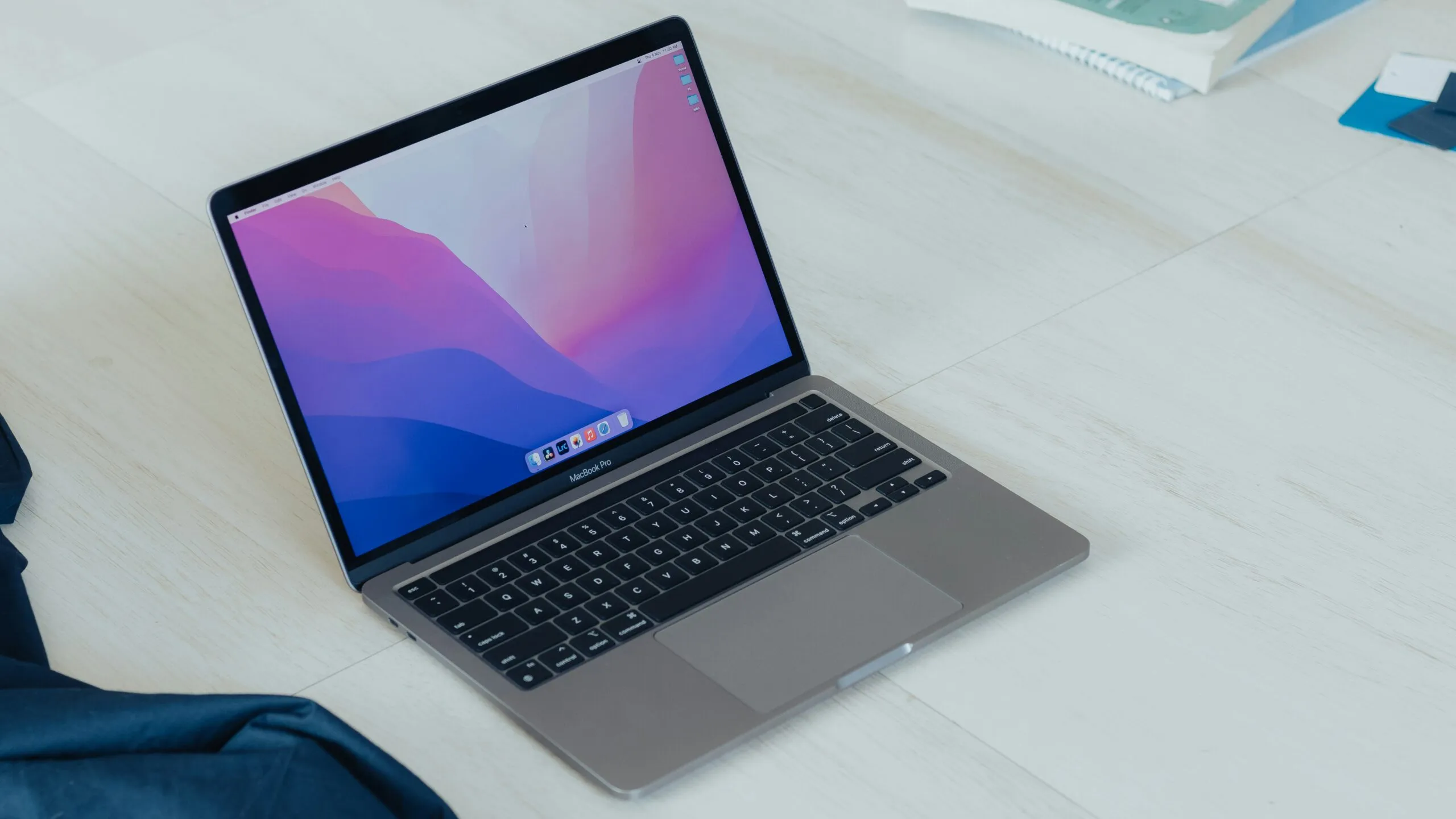 a laptop computer sitting on top of a wooden table