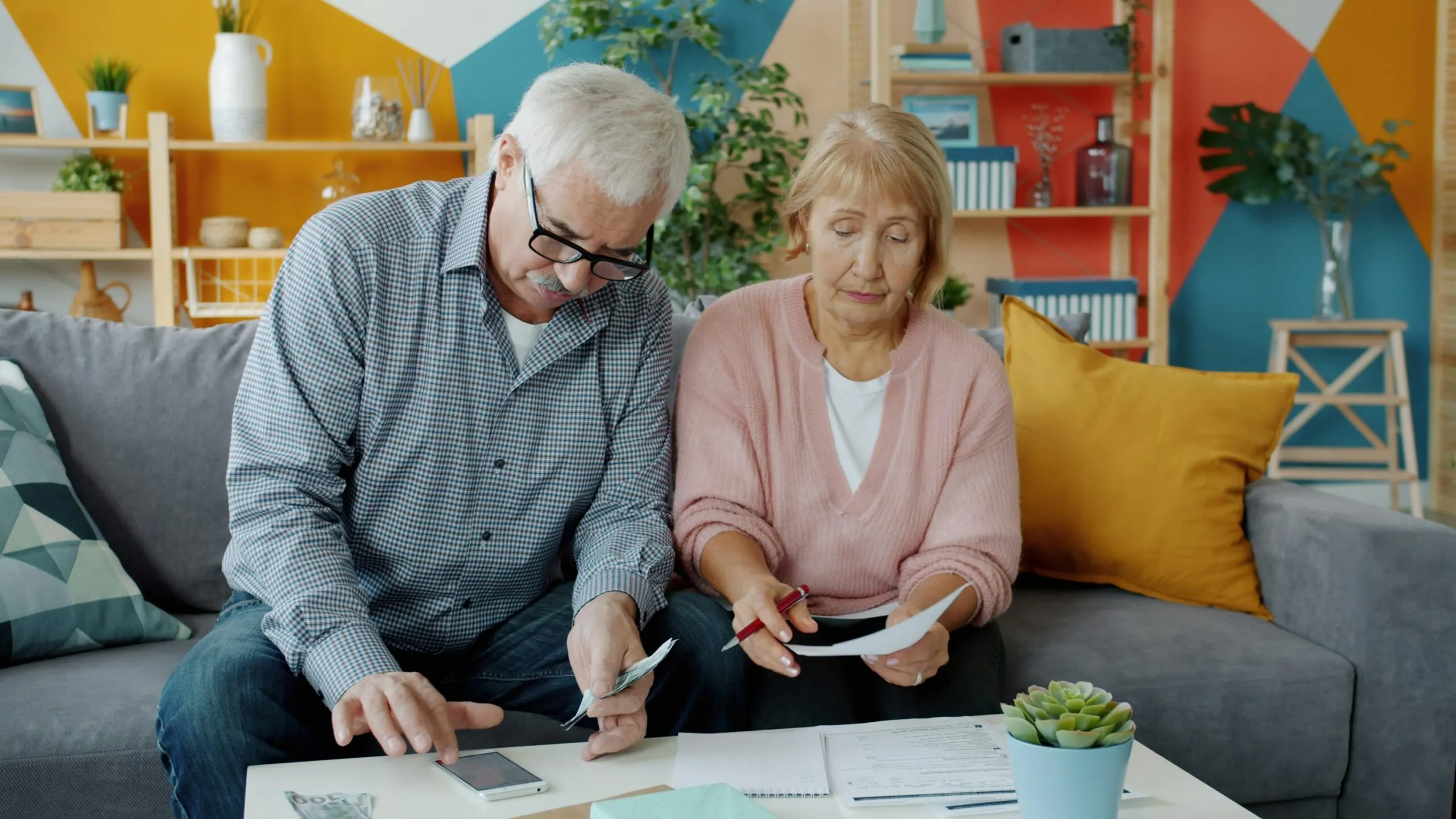 Elderly couple reviewing documents at home
