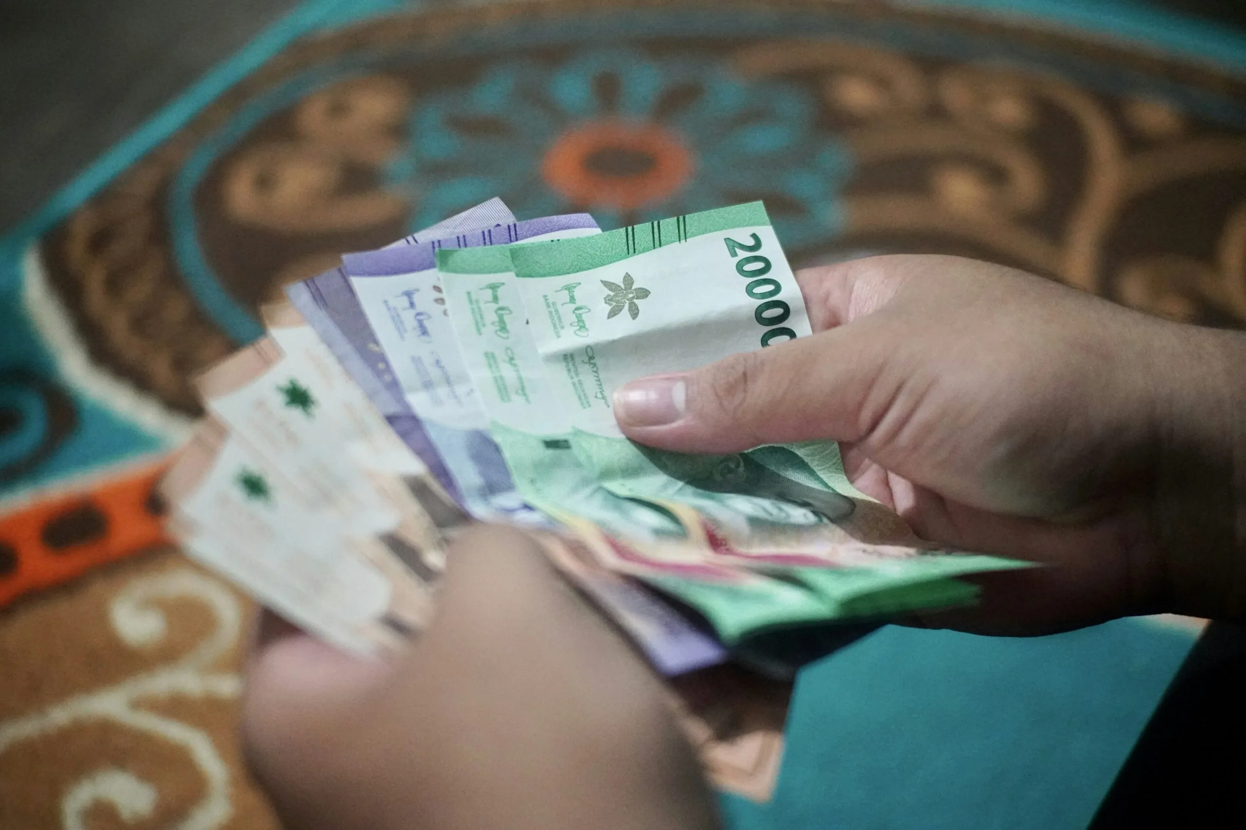 a person holding a bunch of money in their hand