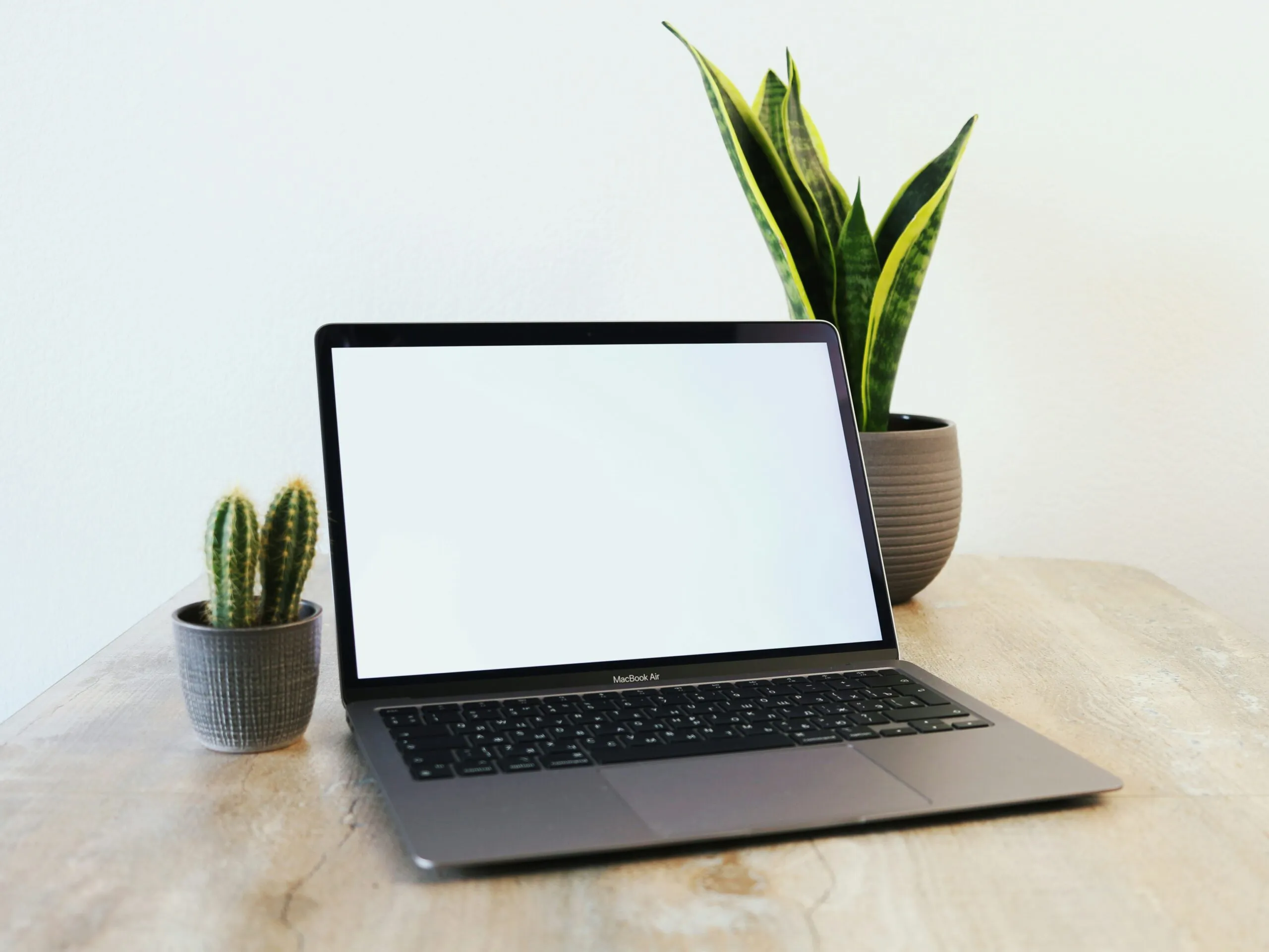 a laptop computer sitting on top of a wooden table