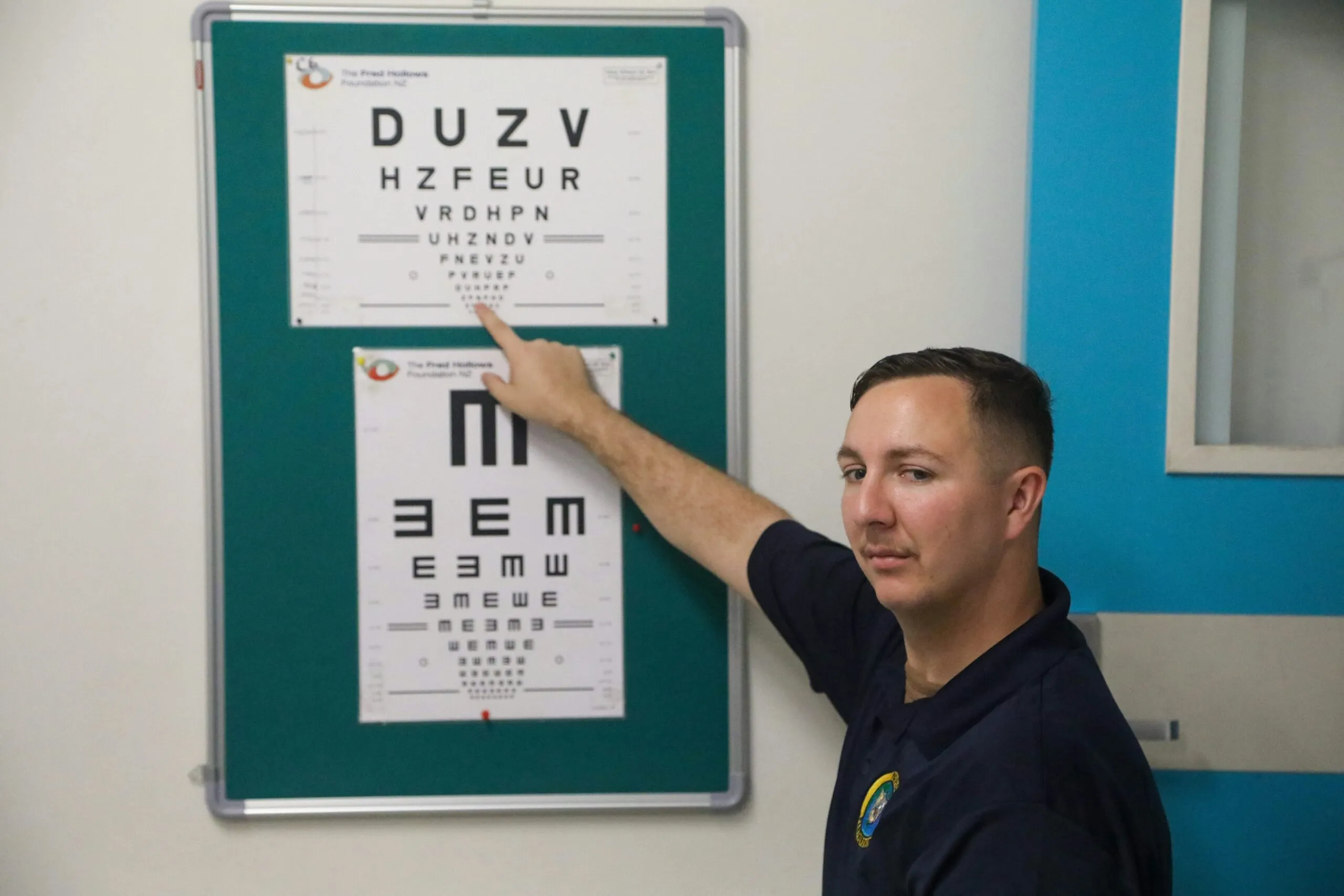 U.S. Navy Hospital Corpsman 1st Class Kaleb Sherwood points to a letter on an eye chart for a patient during a pre-op clinic at the National Referral Hospital in Honiara, Solomon Islands, during Pacific Partnership 2024-1 Nov. 20, 2023. Pacific Partnership, now in its 19th iteration, is the largest multinational humanitarian assistance and disaster relief preparedness mission conducted in the Indo-Pacific and works to enhance regional interoperability and disaster response capabilities, increase security stability in the region, and foster new and enduring friendships. (U.S. Army photo by Cpl. Nathanuel C. Mansfield)