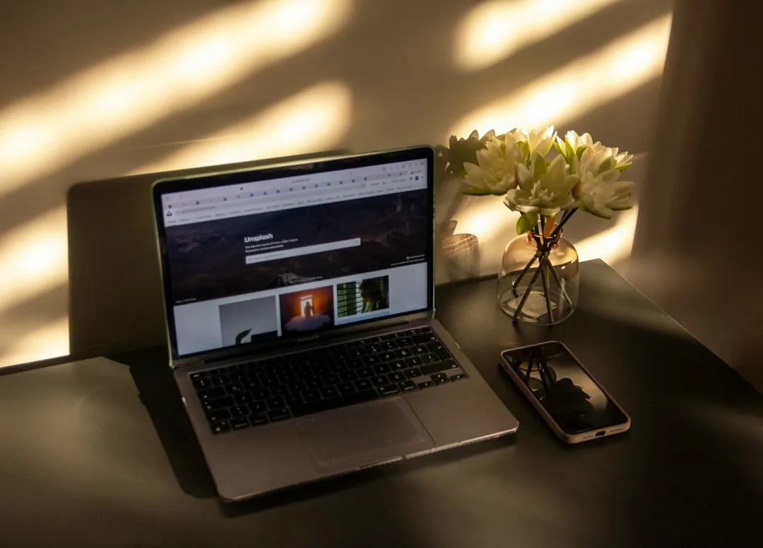 a laptop and a cell phone on a table
