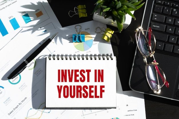 Invest in yourself Note book with text Self improvement concept