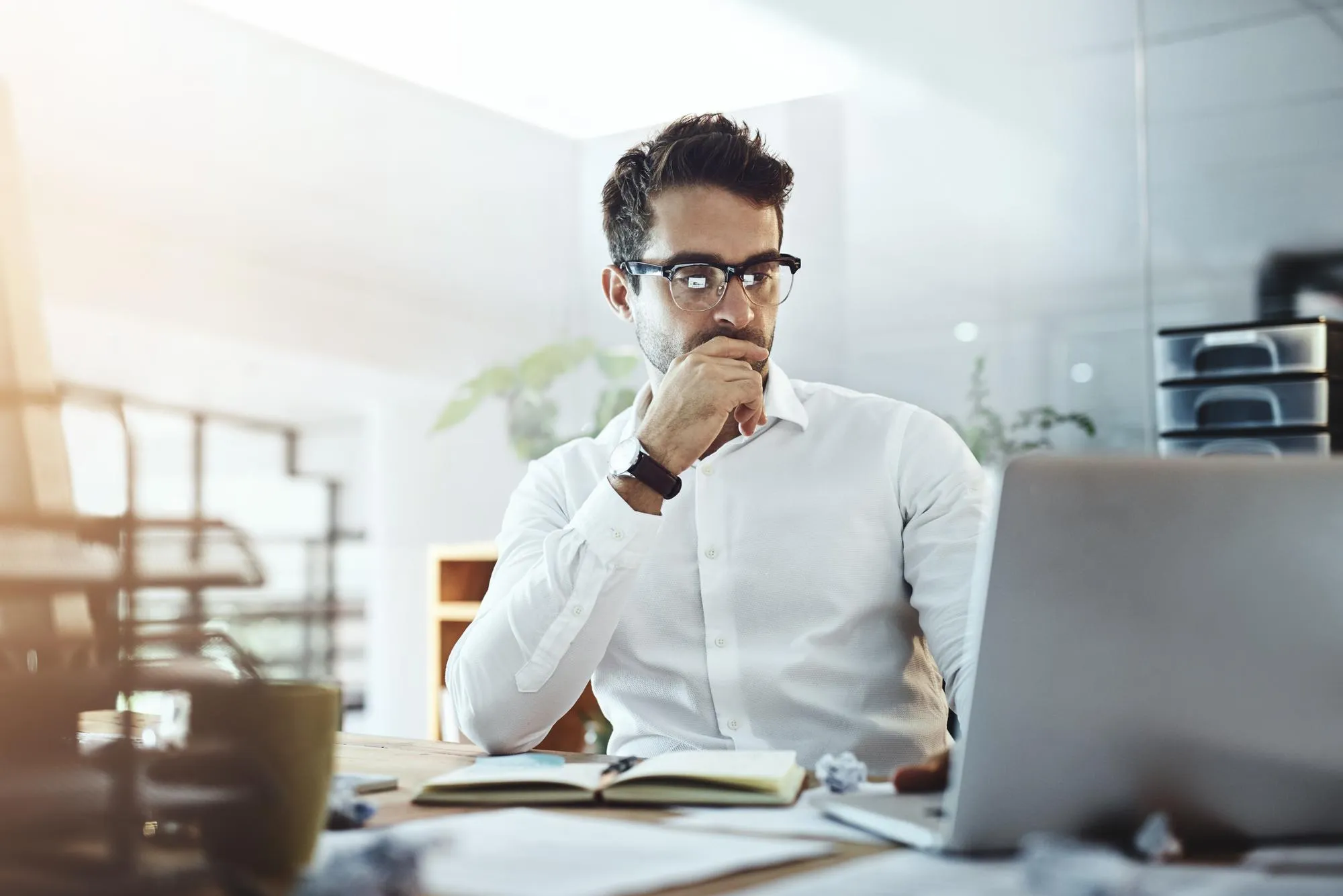 Laptop thinking and business man in office working on project or email Computer professional and male person problem solving looking for solution or planning reading or focus on decision making