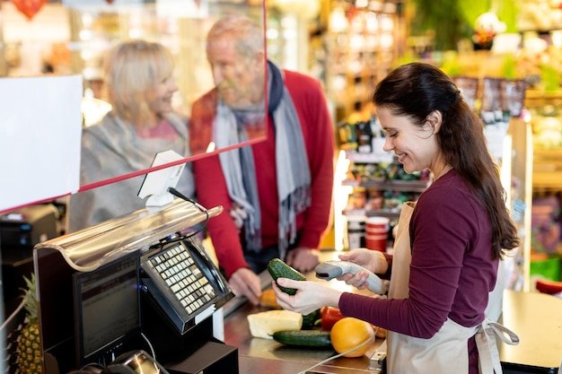 Loving senior couple purchasing at supermarket together