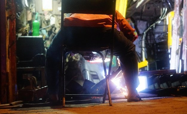 Low section of man working at illuminated room