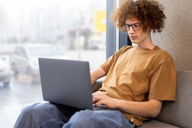 Medium shot man reading digital magazine