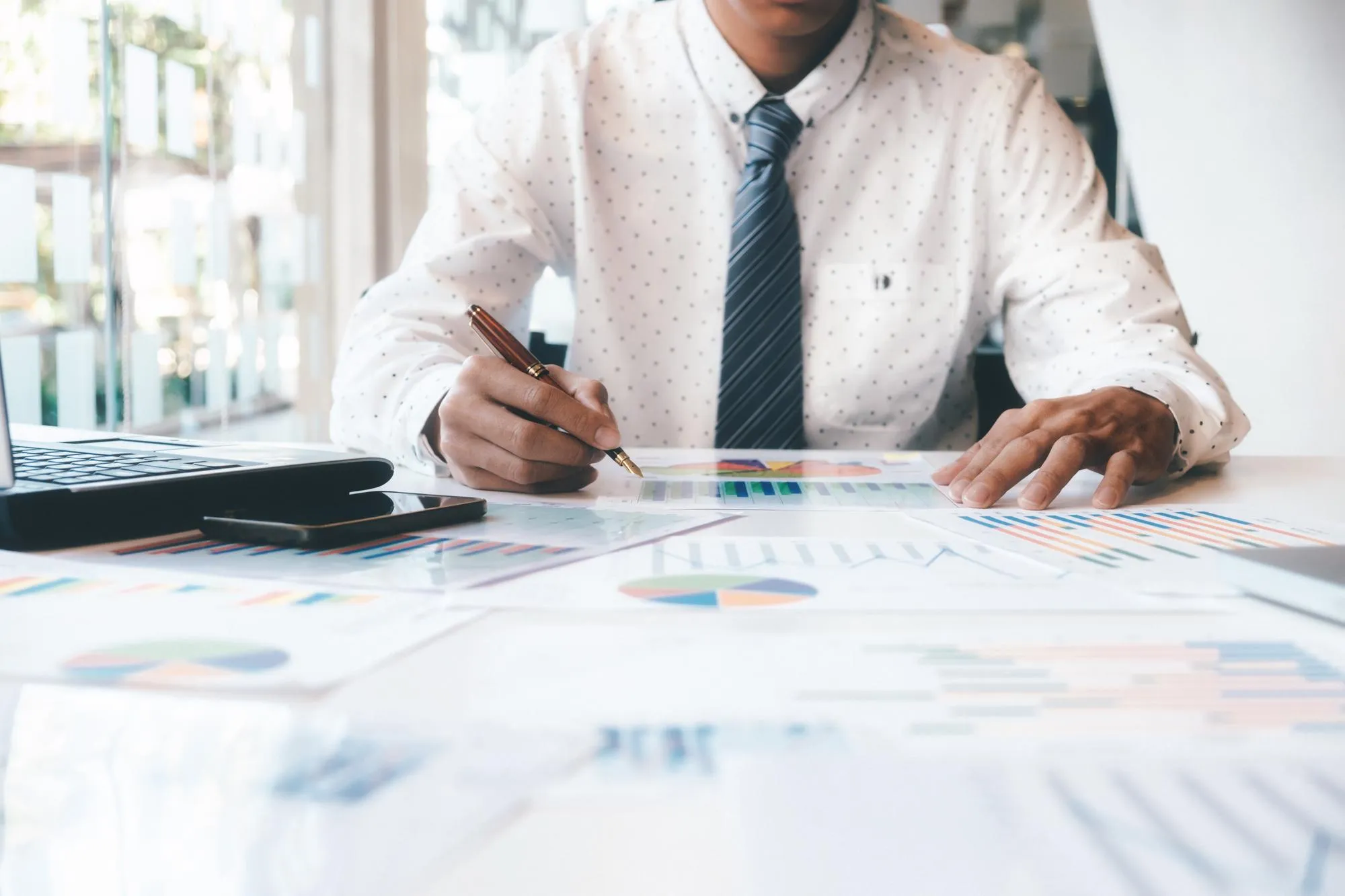 Midsection of businessman at desk in office