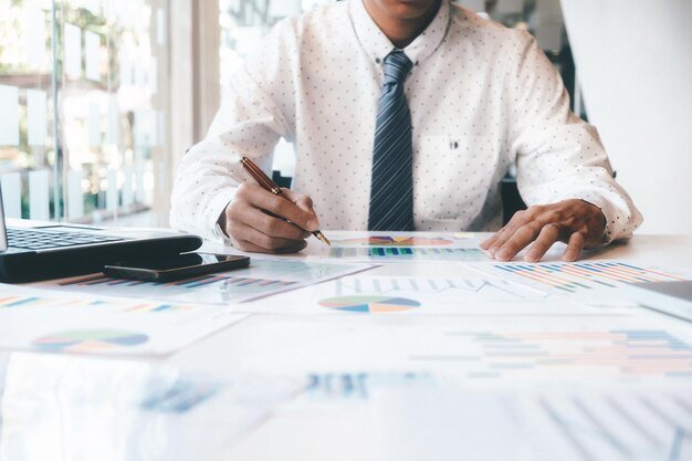 Midsection of businessman at desk in office