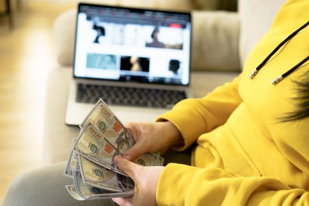 Midsection of woman holding paper currency