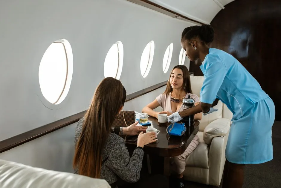 Elegant service in business class onboard a private jet by a professional flight attendant.